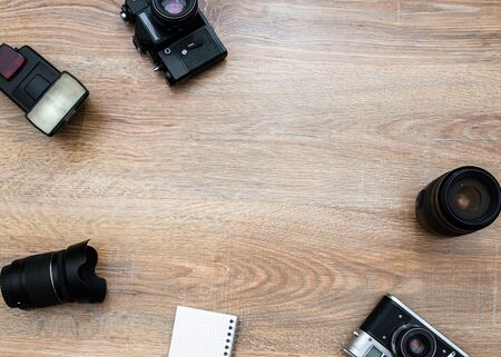 Office table with notebook and cameras.の写真素材