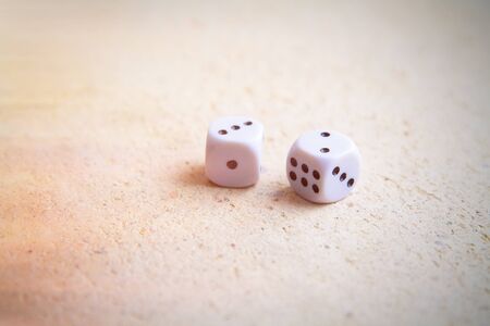 Rolling two dice on a wooden desk.の写真素材