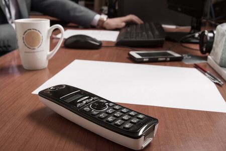 Acounting business man use laptop computer and mobile phone in an office.の写真素材