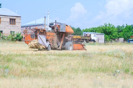 An old tractor working in a fieldの写真素材