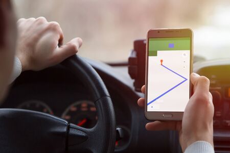 -Navigation app in a telephone on a man's handの写真素材