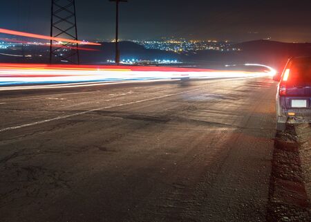 Lights of a car on highway road at nightの写真素材