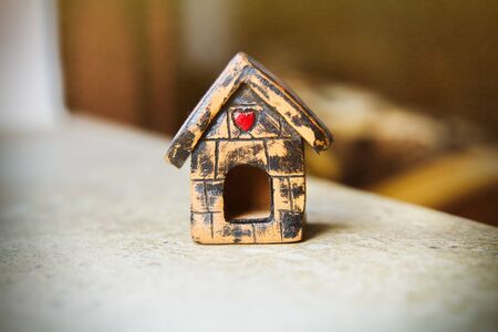 A close up view of wooden figure of house