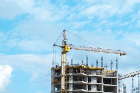 Construction of a high-rise building with a crane.の写真素材