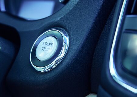 Car dashboard with focus on engine start stop button