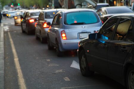 Cars standing in a traffic jam on a city street. の写真素材