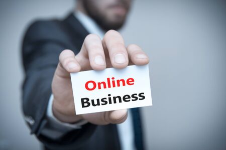 Businessman holding paper with text Online Business. の写真素材