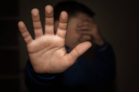 Stressed businessman after business project failure covering eyes in despair and hand gesturing stop...