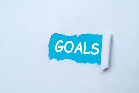 Goals written under tear folded paper, blue and white.の写真素材