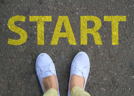Two white sneakers on asphalt and start concept.の写真素材