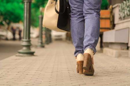 Close up of female legs walking on street.の写真素材