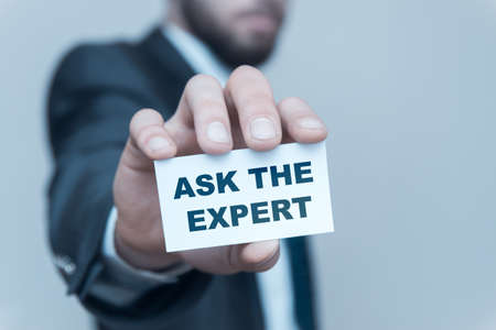 Business man holding Ask An Expert on white studio background.の写真素材