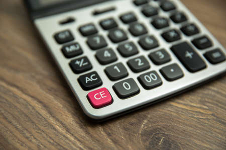 Close up of calculator on wooden table, accounting concept.の写真素材