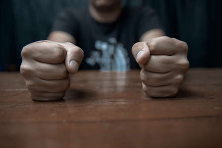 Angry businessman hit fist to table in office workstation.の写真素材