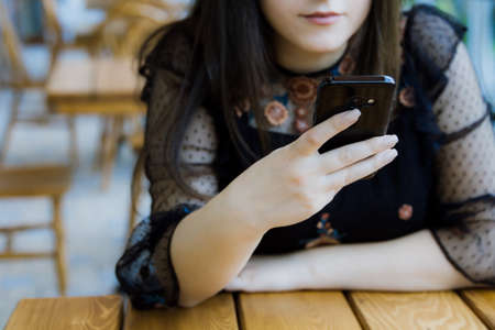 Hands of woman using mobile phoneの写真素材