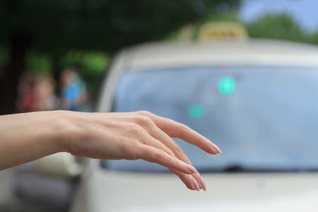 Woman catching taxi on the street.