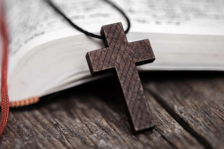 cross on book on wooden backgroundの写真素材
