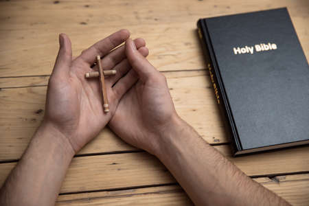 Man praying with hands crossed and Holy Bibleの写真素材