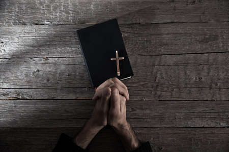 Christian man hand cross with Bibleの写真素材