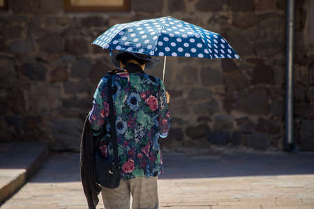A woman in old fashion dresses with umbrella.の写真素材