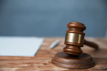 Document with judge on wooden tableの写真素材