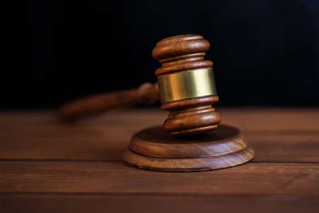 wooden judge on table on black backgroundの写真素材