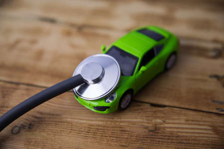 Stethoscope and car on the wooden tableの写真素材