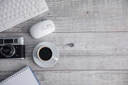 keyboard with camera and coffee on deskの写真素材