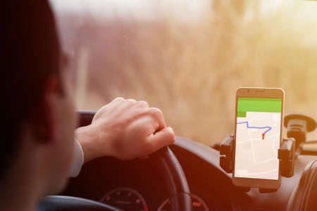 man in car hand smart phone
