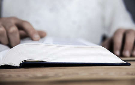 Man reading Bible on the tableの写真素材