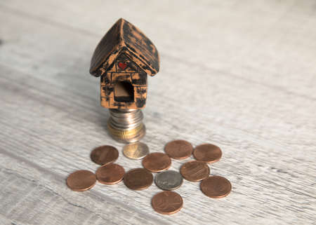 house model on coins on tableの写真素材
