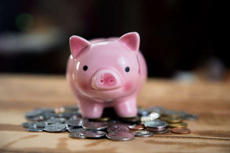 piggy bank with coins on table