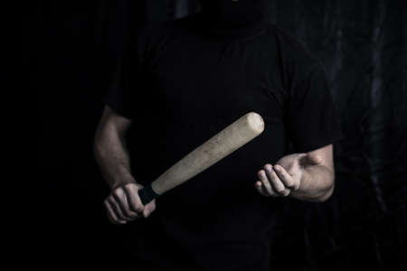 young man hand bat isolated on blackの写真素材