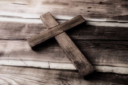 wooden cross on the wooden table backgroundの写真素材
