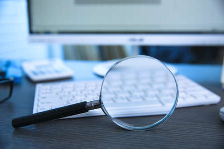 magnifier with keyboard on tableの写真素材
