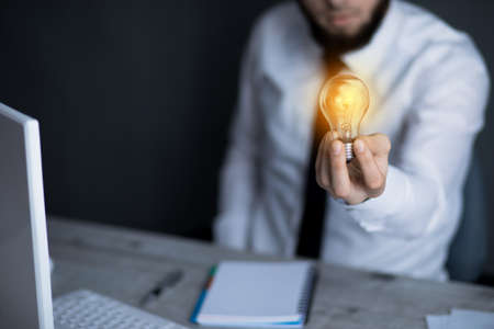 man hand light bulb in deskの写真素材
