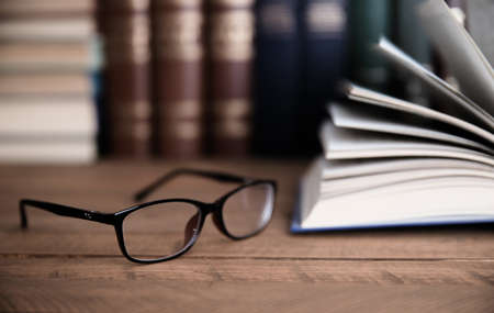 glasses with books on desk