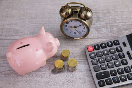 piggy bank with coins and calculatorの写真素材