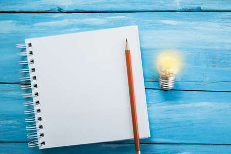 light bulb with pencil on notepadの写真素材