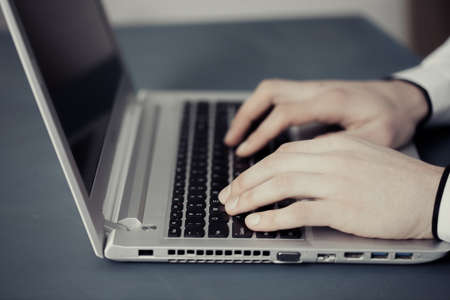 man hand computer keyboard on deskの写真素材
