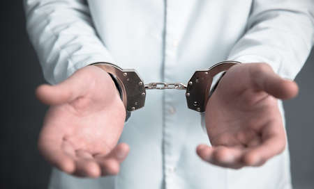 doctor hand handcuffs on the dark background