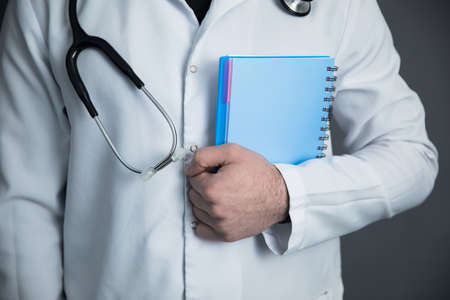 doctor hand notepad on dark background