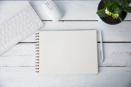 notepad with keyboard on deskの写真素材