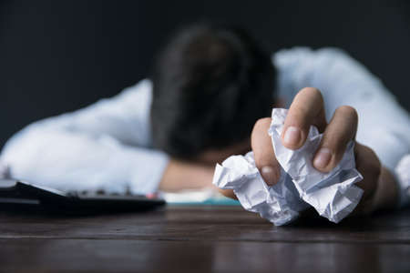 sad man hand paperon deskの写真素材