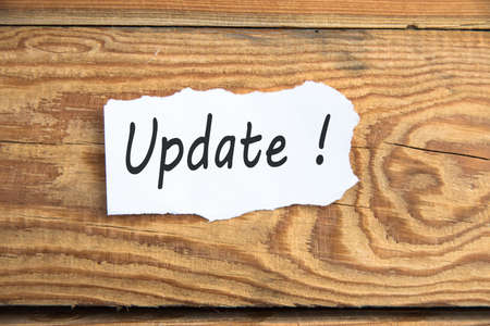 update text on page on wooden tableの写真素材