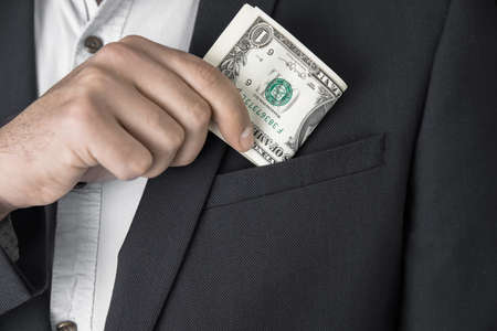 business man hand money on pocketの写真素材