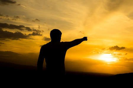 man hand show yellow sunsetの写真素材