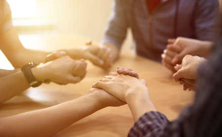 team people hands on wooden deskの写真素材