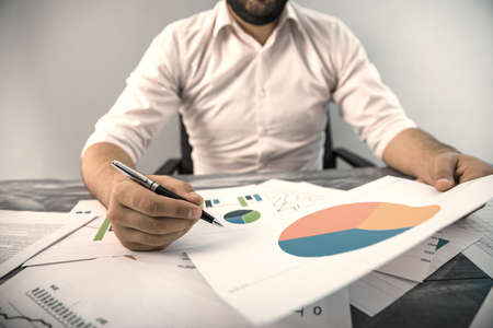 man hand pen with graph on desk