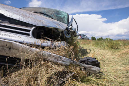 Old car on field grass under skyの写真素材